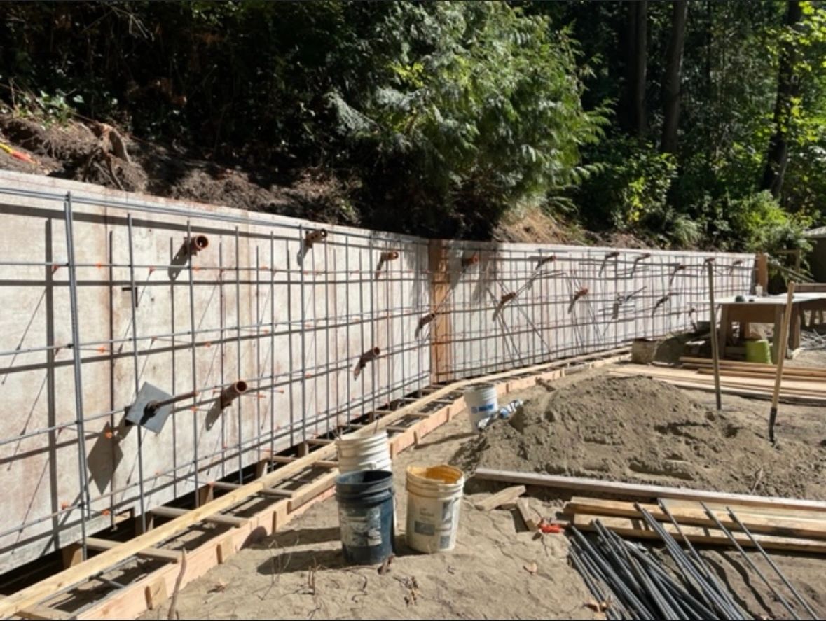 Structural engineering and foundation design for reinforced retaining wall system.